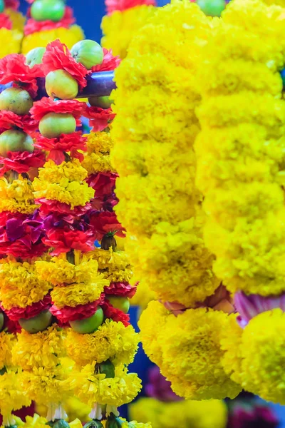 Colorful marigold flower garlands for hindu religious ceremony. Garland of indians for worship goddess in the florist shop nearby Sri Maha Mariamman Temple, Silom, Bangkok, Thailand.