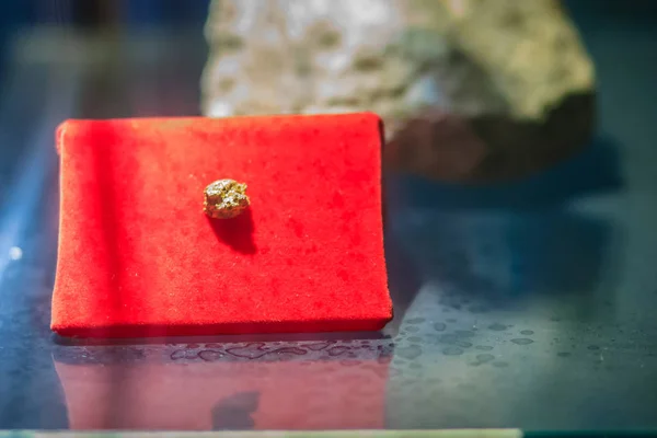 Gold rock specimen from mining. Gold is a chemical element with symbol Au and atomic number 79. In its purest form, it is a bright, slightly reddish yellow, dense, soft, malleable, and ductile metal.