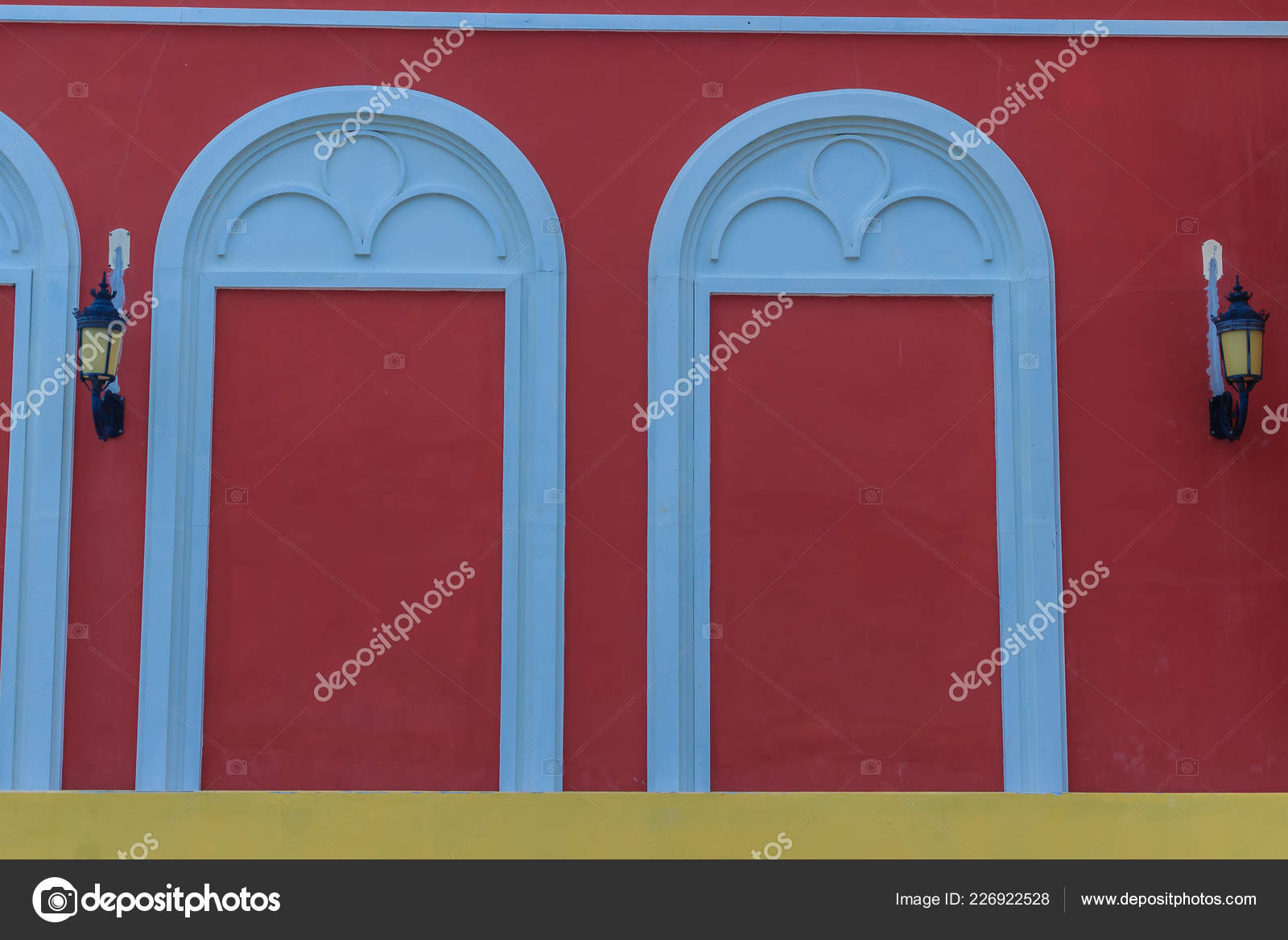Classic White Arch Door Pattern Red Wall Background Stock Photo by