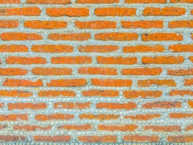 Laterite taş blok ve çakıl dash desende sınır çit duvar. Laterite taş duvar desen çakıl tire doku arka plan ile engellemek.