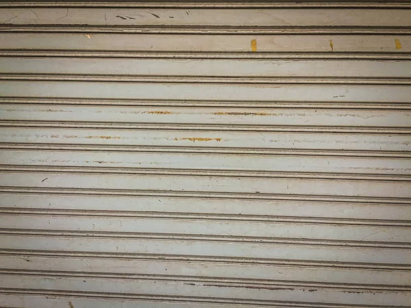 Grungy steel roller shutter door background. Garage or factory storage gate roller shutter door background.