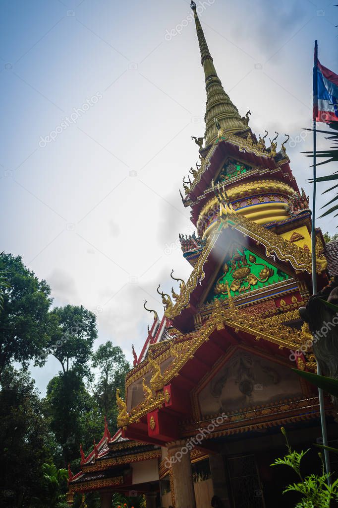 Beautiful golden pagoda with decorative Thai style fine art at public Buddhist Wat Phu Phlan Sung, Nachaluay, Ubon Ratchathani, Thailand.