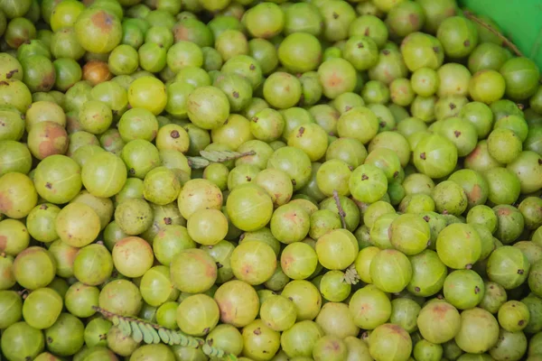 Indian gooseberry (Phyllanthus emblica), also known as emblic, emblic myrobalan, myrobalan, Indian gooseberry, Malacca tree, or amla fruit. Emblic fruits for sale in the fruit market, Thailand.