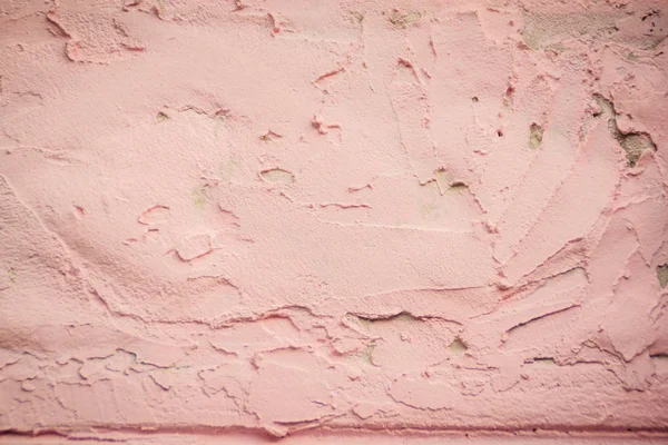 Rough pink plastered wall texture. Abstract decorative pink plastered wall or purple color painted stucco. Pink plastered handmade rough wall paper.