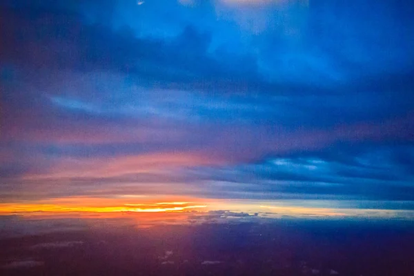 Dusk sky and cloud at morning dawn background. Vibrant colors of the sky with clouds from dusk till dawn. Dramatic evening cloudscape in the city. Twilight sky began to change from blue to orange.