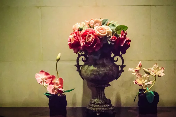 Glass vase and flowers decoration with spotlight. Hotel room decoration with spotlight illuminates to flowers in glass vase.