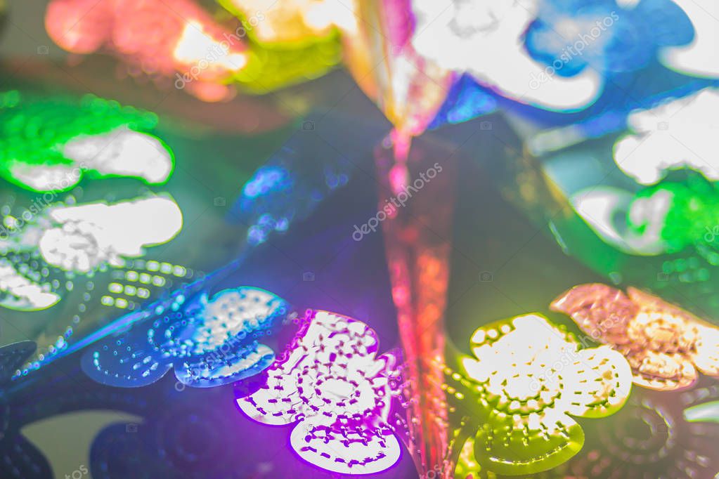 Abstract blurred colorful garlands are hanging on the ceiling at the office to decoration prepare for Christmas and new year party cerebration.