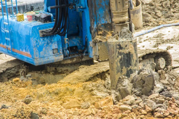 Hydraulic drilling machine is boring holes in the construction site for bored piles work. Bored piles are reinforced concrete elements cast into drilled holes, also known as replacement piles.