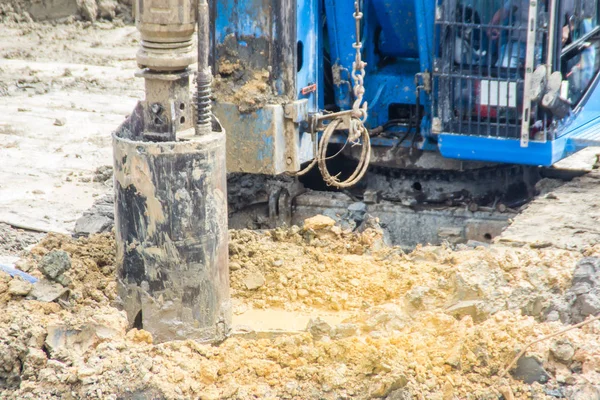 Hydraulic drilling machine is boring holes in the construction site for bored piles work. Bored piles are reinforced concrete elements cast into drilled holes, also known as replacement piles.