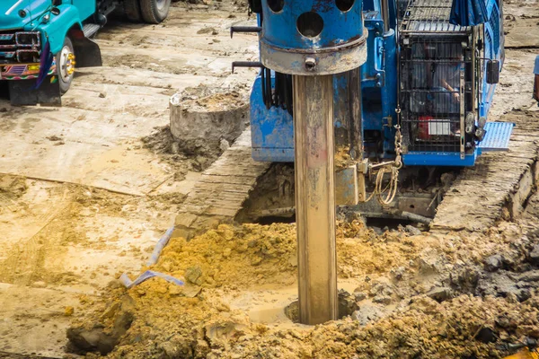 Hydraulic drilling machine is boring holes in the construction site for bored piles work. Bored piles are reinforced concrete elements cast into drilled holes, also known as replacement piles. — Stock Image Hydraulic Drilling Machine Boring Holes Construction Site Bored Piles Work Stock Photo