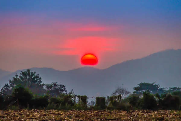 Sunset in the valley of corn field after harvested at Khao Yai national park, Nakhon Ratchsima, Thailand. Calm valley during dawn with sunrise in the morning.