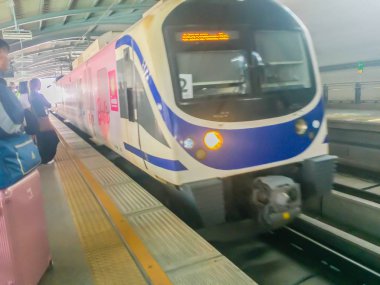 Bangkok, Tayland - 12 Ocak 2018: Yolcular Havaalanı Demiryolu bağlantı gökyüzü treni varış bekliyor. İnsanlar düzenli bir çizginin arkasına doğru parça sarı oklar beklemek.