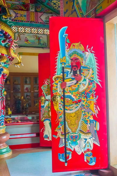 Colorful red Guan Yu painting with blade as the guardian on the door in the public Chinese temple. Guan Yu is the god warrior in the Three Kingdoms period.