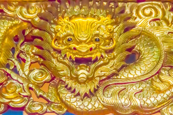 Beautiful golden chinese dragon head sculpture shining in the public Chinese temple. Chinese dragons, also known as East Asian dragons, are legendary creatures in Chinese mythology, Chinese folklore.