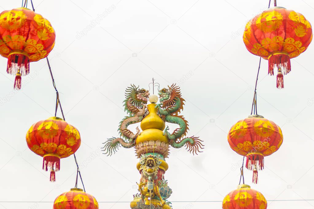 Colorful statue of Chinese dragon wrapped around the pillar. Beautiful statue of dragon carved around temple pole in Chinese public temple.