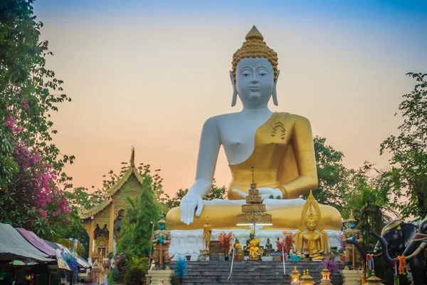 Beautiful big buddha image at Wat Phra That Doi Kham. Chiang Mai, Thailand. Wat Phra That Doi Kham (Wat Doi Kham or the Golden temple) is located at the top of a hill to the south west of the city.