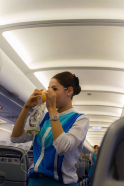 Bangkok, Tayland - 13 Haziran 2017: Bangkok Havayolları hostes uçuş görevlisi uçaktaki yolculara güvenlik ekipmanlarını açıklar, yolculara güvenlik prosedürlerini gösterir