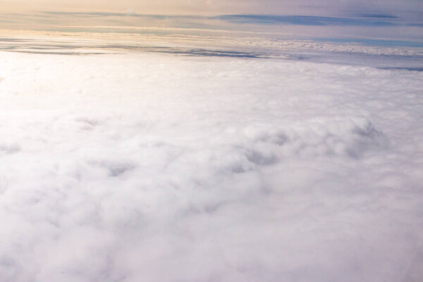 Beautiful cloudscape and blue sky from aerial view, nature view from above the sky and clouds. White clouds and blue sky view like the heaven from airplane window. Sunlight in the sky shines on clouds