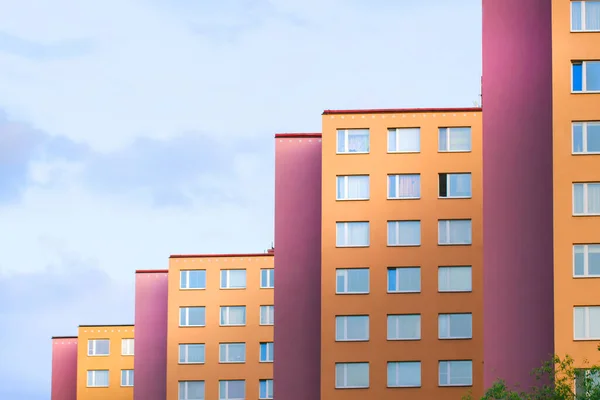 Colorful multicolored walls of a panel residential building form repeating geometric elements.Urban landscape against the sky
