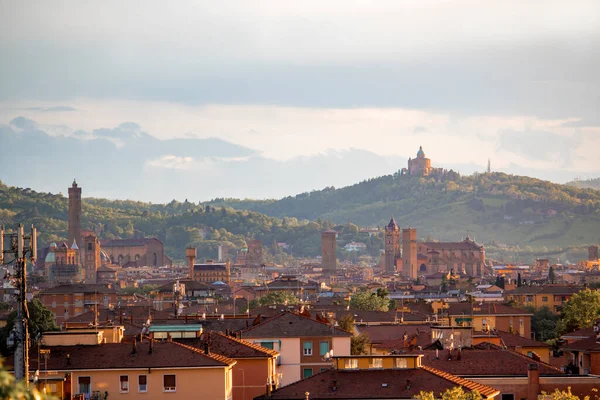 Eski Bologna şehrinin hava panoramik manzarası. Asinelli Kulesi, Torre, San Petronio Kilisesi, Bazilika ve San Luca Kilisesi veya Bazilikası 'nı görmektedir. Bulutlu ve gün batımlı gökyüzü ve arka planda Bolonez tepeleri