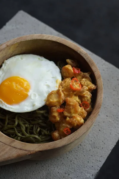 Healthy Green Noodle in a Wooden Bowl with Sunny Side Up Egg