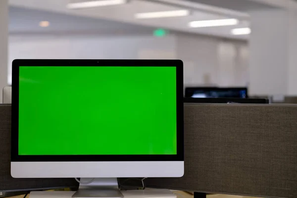 Close up one green screen desktop computer display in modern office. Blur background
