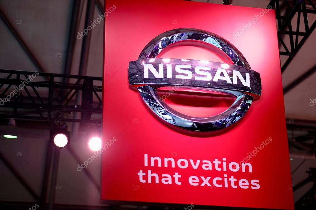 Shiny silver brand logo of Nissan Corporation on red board. With slogan Innovation that excites. Famous Japanese multinational automobile manufacturer. Shoot at CES ASIA