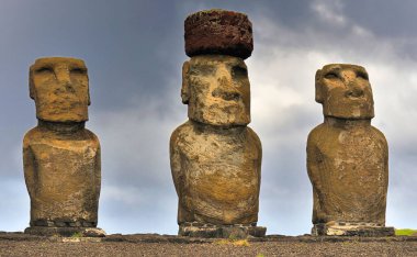 Close-up view of three moai statues against cloudy sky, Easter Island, Chile (Rapa Nui) clipart