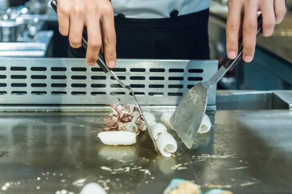 cook turn around octopus  on metallic platter