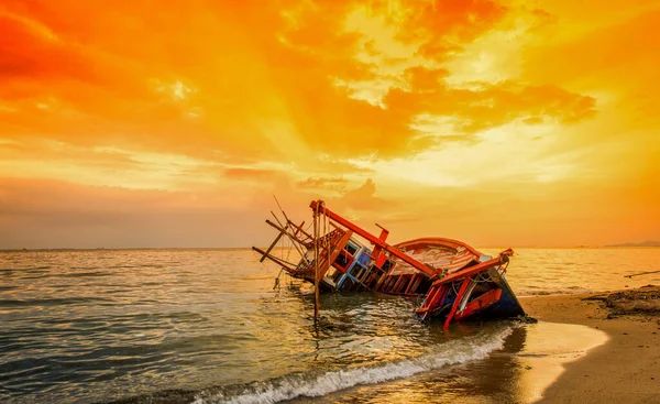 Abandoned boat in stormy sea, Wooden boat in a stormy sea, Boat damaged, Boat crash, Sunset The beach on the sea