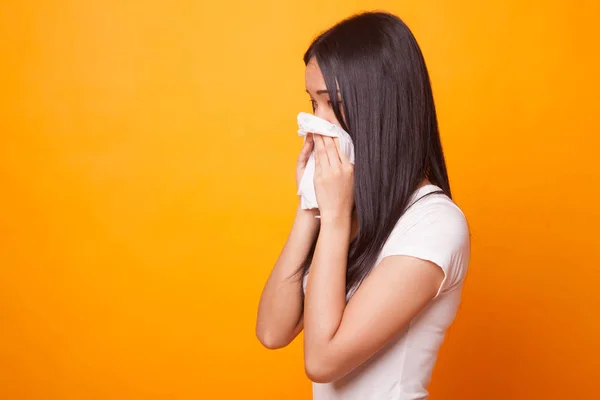 Young Asian woman got sick and flu on bright yellow background