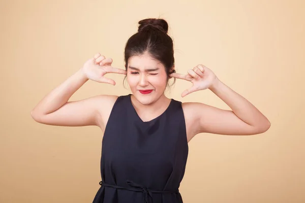 Young Asian Woman Block Both Ears Finger Beige Background — Stock Photo, Image