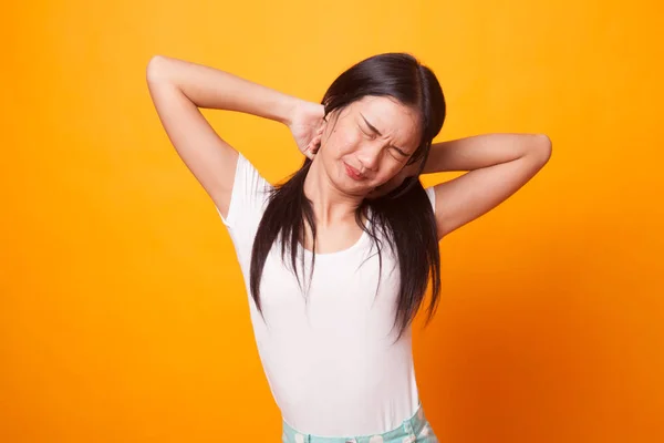 Sleepy young Asian woman yawn on bright yellow background