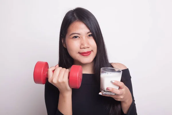 Healthy Asian woman drinking a glass of milk and dumbbell on white background