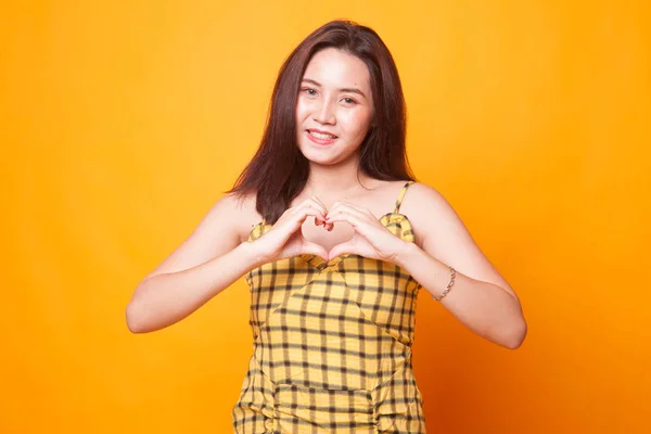 Young Asian Woman Show Heart Hand Sign Yellow Background — Stock Photo, Image