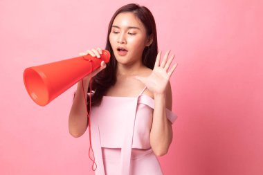 Genç Asyalı kadın pembe arka plan hakkında bir kitap okudu.