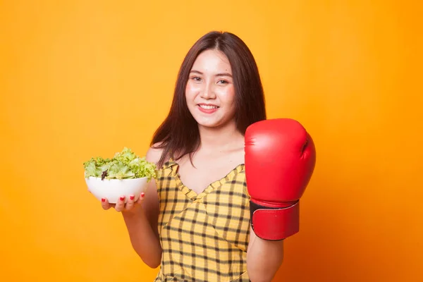 Young Asian Woman Boxing Glove Salad Yellow Background — Stock Photo, Image