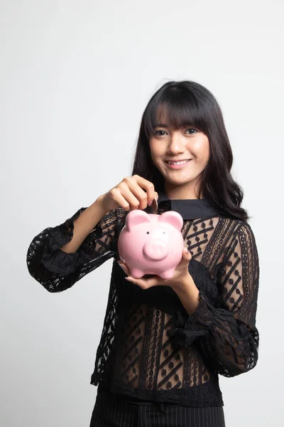 Asian woman with coin and pig coin bank. — Stock Photo, Image