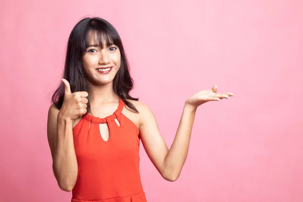 Hermosa joven asiática mostrar la palma de la mano y pulgares hacia arriba . — Foto de Stock