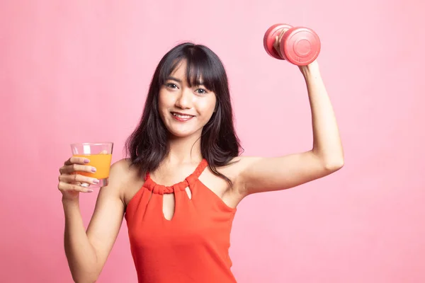 Young Asian woman with dumbbell drink orange juice. — Stock Photo, Image