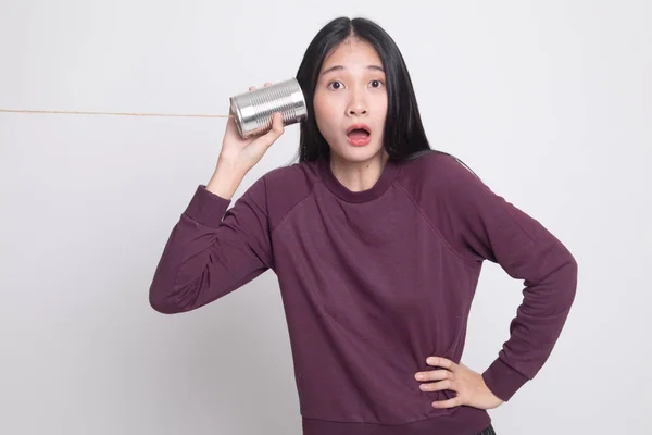 Surprised young Asian woman with tin can phone. — Stock Photo, Image