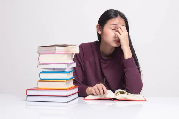 Exhausted Asian woman got headache read a book with books on tab — Stock Photo, Image