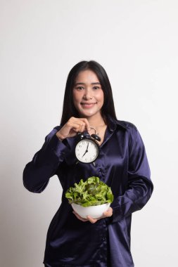 Saat ve salata ile genç Asyalı kadın.