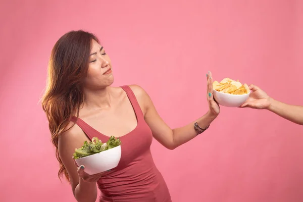 Giovane donna asiatica con insalata dire di no alle patatine fritte . — Foto Stock