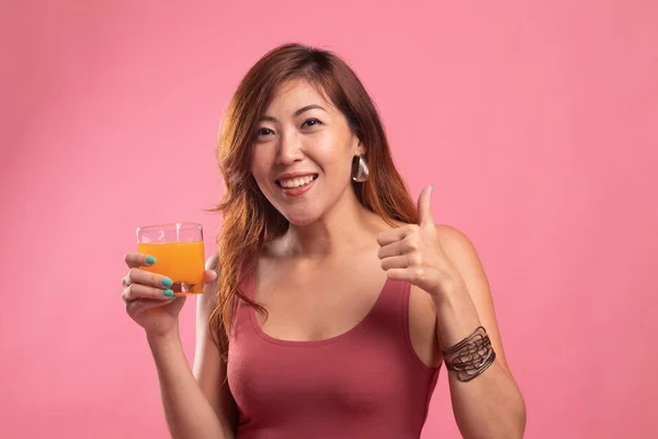 Young Asian woman thumbs up drink orange juice.