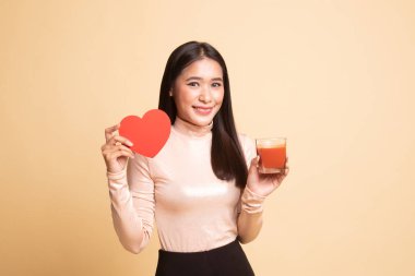 Domates suyu ve kırmızı kalpli genç Asyalı kadın.