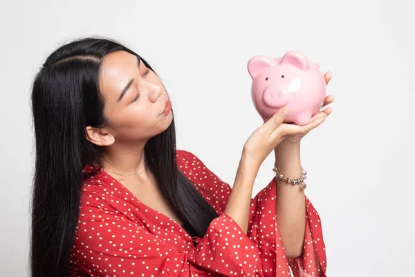 Mladá asijská žena kiss růžová mince banka. — Stock fotografie