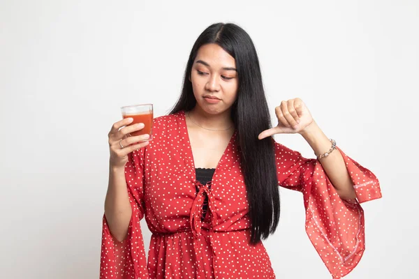 Asian woman thumbs down  hate tomato juice.