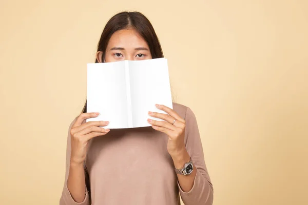 Молодая азиатка с книжной обложкой на лице . — стоковое фото