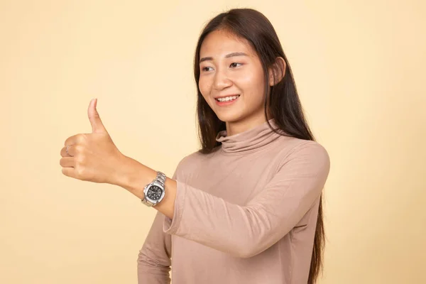 Asian woman thumbs up  and smile.